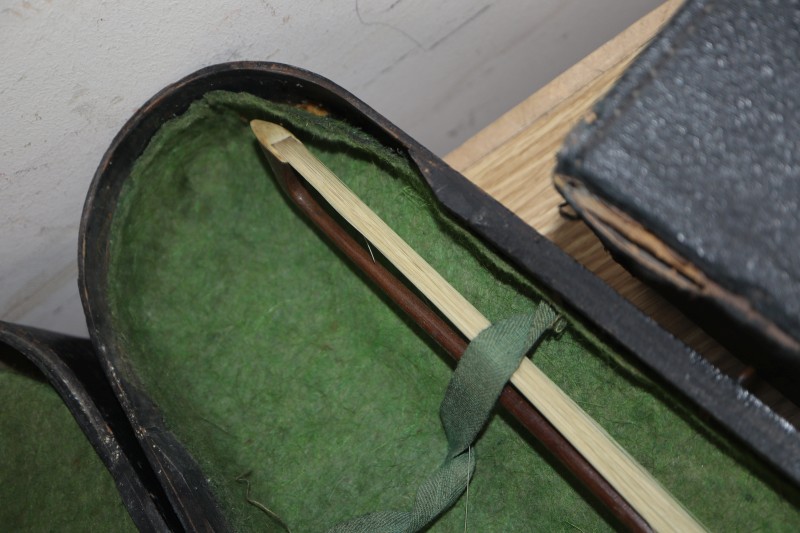 An early 20th century Saxon violin cased with bow and a cased banjo